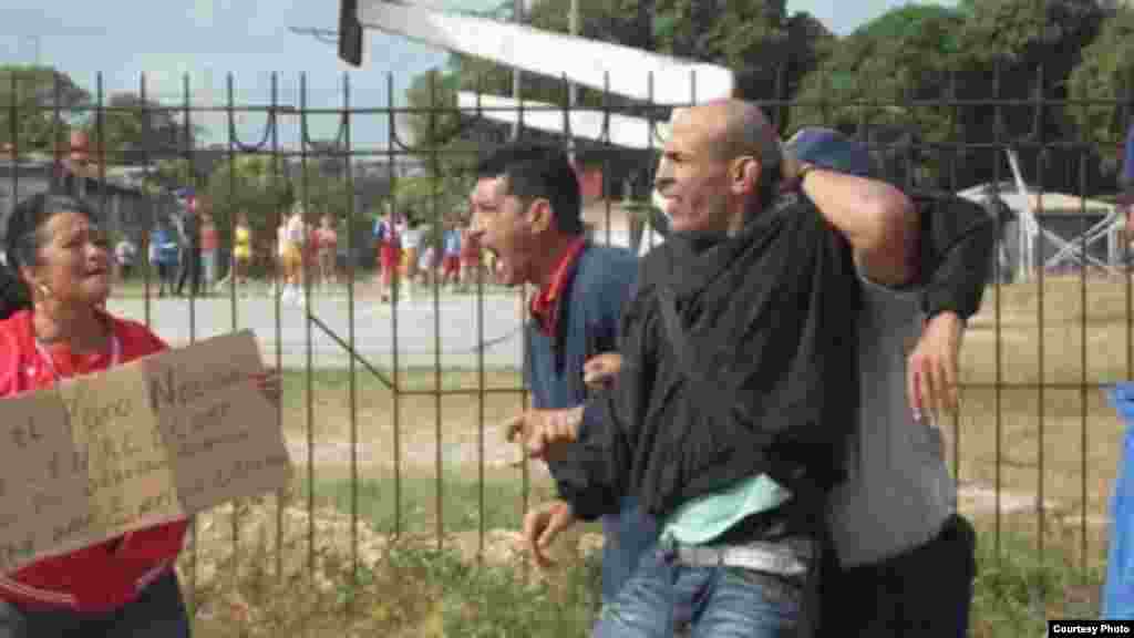 Arresto&nbsp; en Sagua La Grande del opositor Luis E Santos, a su lado Onelia Alonso&nbsp; activista de la Coalici&oacute;n Central Opositora porta una cartel pidiendo la libertad del preso pol&iacute;tico Enrique Esteban Prieto. De los activistas que participaron nueve fueron detenidos y liberadso horas despu&eacute;s seg&uacute;n destac&oacute; Maria del Carmen Hern&aacute;ndez que se retir&oacute; de la&nbsp; protesta para poder salvar las im&aacute;genes del arresto.