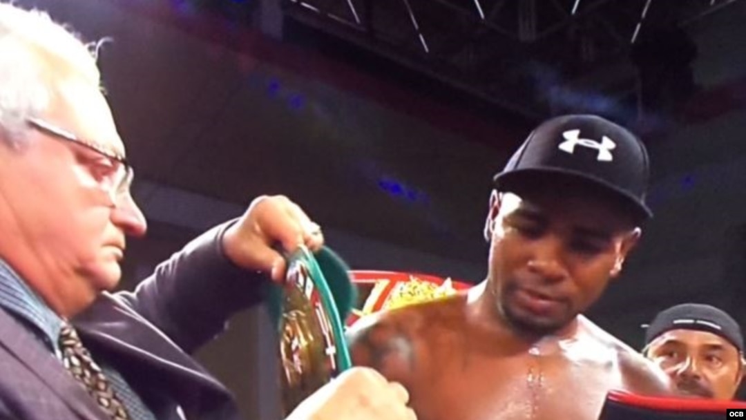 El doctor cubano Ramón García-Septien entrega el cinturón Latino del Consejo Mundial de Boxeo, al peso crucero Yunier Dorticós, durante la cartelera boxística realizada en Kissimmee, Florida.