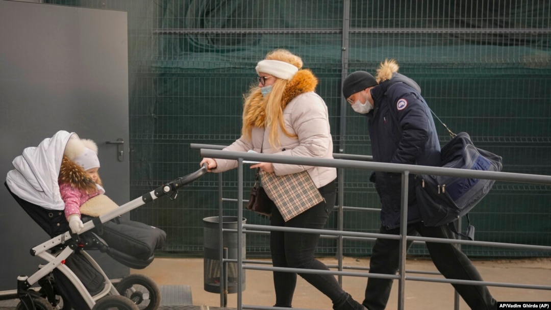 Personas cruzan desde el territorio controlado por Rusia a Stanytsia Luhanska, el único punto de cruce abierto diariamente, en la región de Luhansk, en el este de Ucrania, en febrero. Foto: © Vadim Ghirda/AP Images.