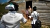 Trabajadores de salud realizan una pesquisa de COVID-19 en un barrio periférico de la localidad de Zaragoza, Mayabeque. (YAMIL LAGE / AFP)