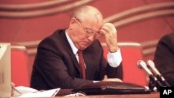 Soviet President Mikhail Gorbachev bows his head in the Congress of People's Deputies shortly after Foreign Minister Edvard Shevardnadze announced his plan to resign in Moscow, Dec. 20, 1990.  (AP Photo/Boris Yurchenko)