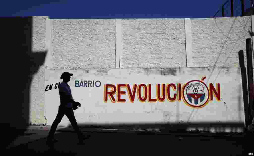 Un hombre camina junto a un cartel alusivo a la revolución cubana hoy, lunes 14 de marzo de 2016, en La Habana.