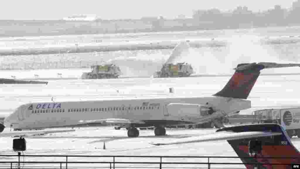 Máquinas quitanieves trabajan en una de las pistas del aeropuerto JFK de Nueva York