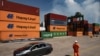 A worker stands in front of containers in the container terminal in the port of Mariel, Artemisa Province, Cuba, on September 20, 2023. (Photo by Yamil LAGE / AFP)