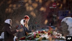 Jóvenes rinden tributo a Alexei Navalny, el 19 de febrero de 2024 en el monumento Solovetsky, en Moscú. (AP Photo/Alexander Zemlianichenko).