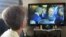 Una mujer mira en la TV cubana el encuentro entre Raúl Castro y Barack Obama en la VII Cumbre de las Américas. 
