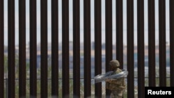 Un oficial repara el muro fronterizo entre Estados Unidos y México para reforzar la seguridad en El Paso, Texas, visto desde Ciudad Juárez, México, el 23 de julio de 2025. REUTERS/Jose Luis Gonzalez/Archivo