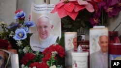 Velas y una foto del papa Francisco se ven frente al Policlínico Agostino Gemelli, en Roma, el sábado 22 de febrero de 2025, donde el pontífice está hospitalizado desde el viernes 14 de febrero. (Foto AP/Alessandra Tarantino)