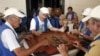 Un grupo de ancianos españolesjuegan al dominó en la Sociedad Canaria de Cuba Leonor Pérez en La Habana.