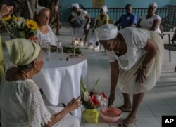 Santeras cubanas realizan una celebración espiritual por la salud del papa Francisco, en la Asociación Cultural Yoruba de Cuba, en La Habana.