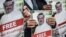 Manifestantes sostienen fotos del periodista saudí y colaborador del Washington Post Jamal Khashoggi. 