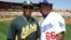 Yoenis Céspedes (i) se encuentra con Yasiel Puig durante un partido de entrenamiento en Phoenix, Arizona. 